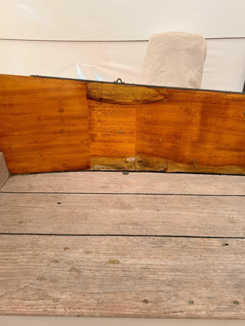 Slide: The Image of Interior view of a 1969 Ohlson 38 sailboat, featuring wooden paneling and flooring. - 9