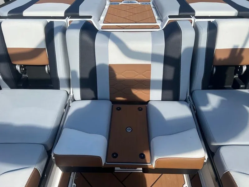 Slide: The Image of 2025 Malibu 23 LSV boat interior with stylish brown and gray seating. - 10