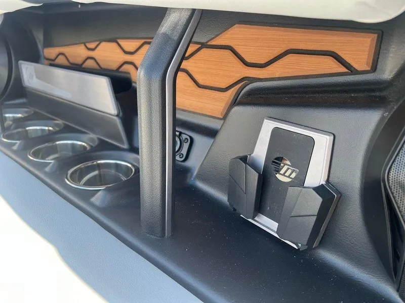 Slide: The Image of 2025 Malibu 23 LSV interior detail with cup holders and modern design elements. - 13