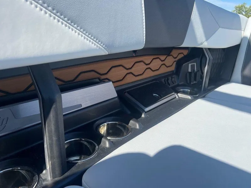 Slide: The Image of Interior of 2025 Malibu 23 LSV boat with modern seating and cup holders. - 14