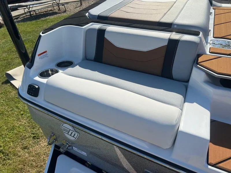 Slide: The Image of 2025 Malibu 23 LSV boat seat with cup holder, featuring sleek design and comfortable upholstery. - 21