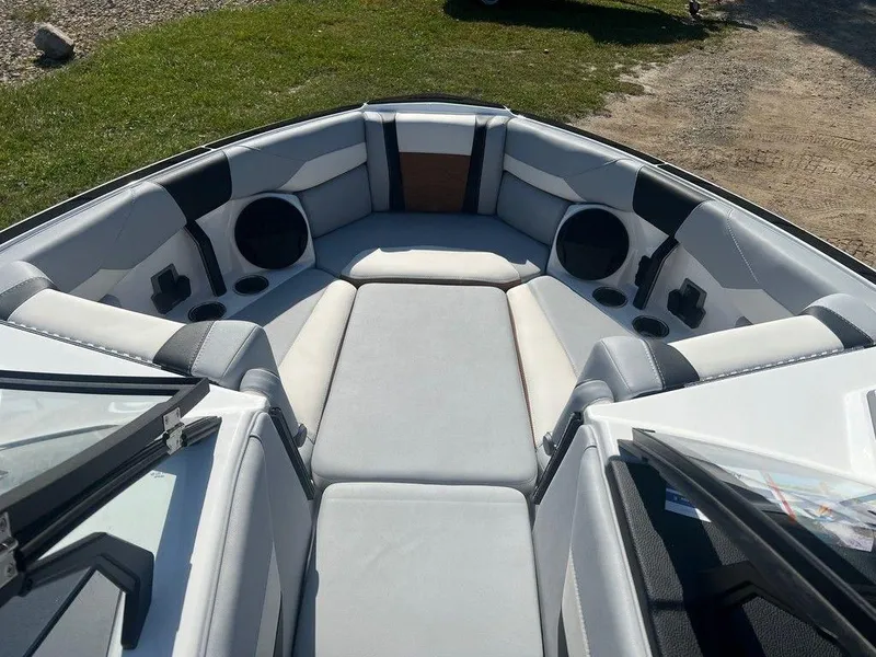 Slide: The Image of 2025 Malibu 23 LSV boat interior with cushioned seating and speakers. - 5