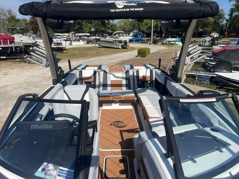 Slide: The Image of 2025 Malibu 23 LSV boat interior with sleek seating and modern design. - 6