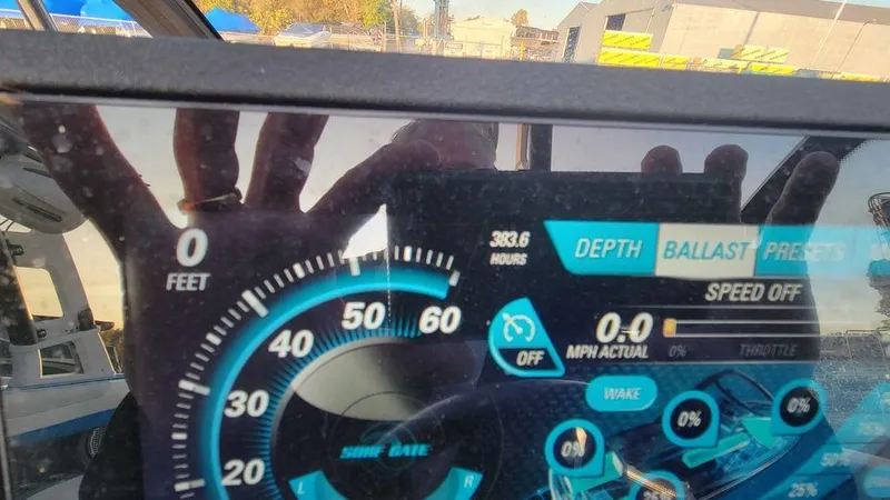 Slide: The Image of Dashboard of a 2015 Malibu 24 MXZ boat showing speed and depth indicators. - 13
