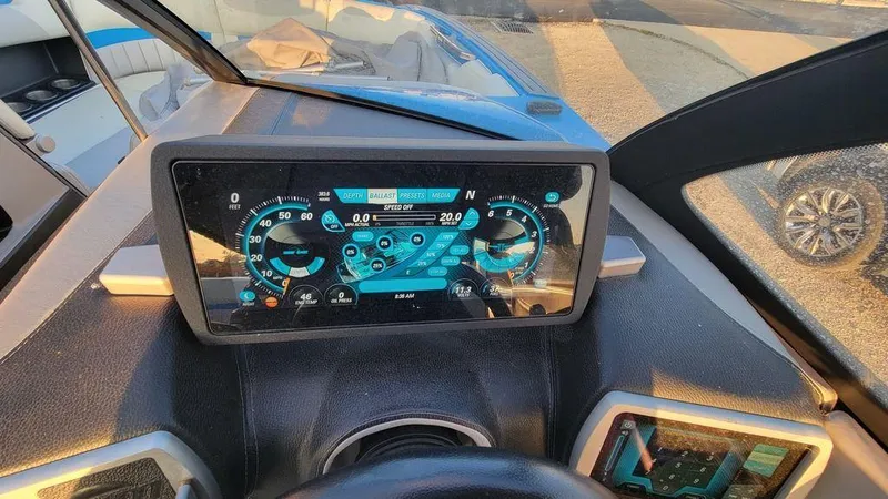 Slide: The Image of Dashboard of a 2015 Malibu 24 MXZ boat with digital display and controls. - 15