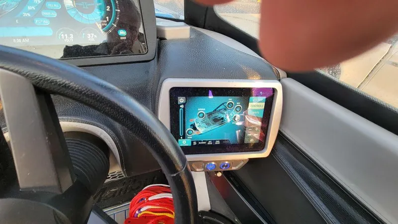 Slide: The Image of Dashboard of a 2015 Malibu 24 MXZ boat with touchscreen controls. - 17
