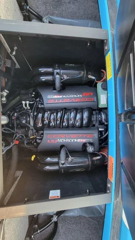 Slide: The Image of 2015 Malibu 24 MXZ engine compartment showcasing powerful inboard motor. - 19