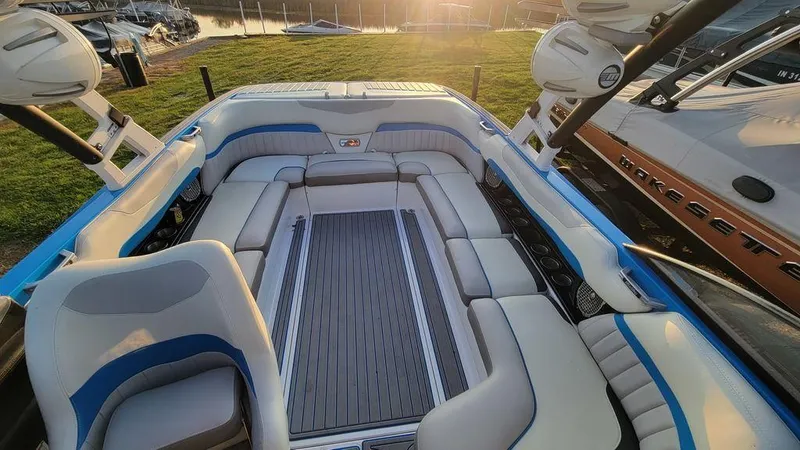 Slide: The Image of 2015 Malibu 24 MXZ boat interior with spacious seating and elegant design. - 7