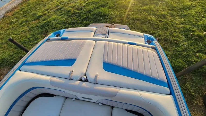 Slide: The Image of 2015 Malibu 24 MXZ boat with blue and white seating, viewed from above. - 9