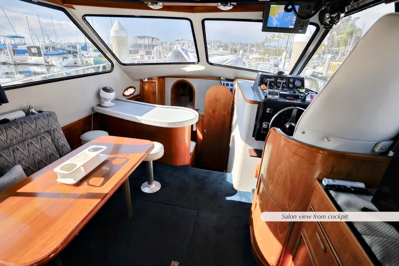 Slide: The Image of Interior of 1988 Mediterranean 38 Convertible yacht, featuring cockpit and salon with wooden furnishings. - 10