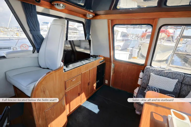 Slide: The Image of Interior of 1988 Mediterranean 38 Convertible yacht with helm seat and saloon view. - 11