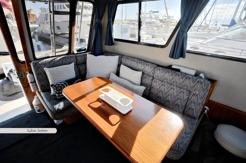 Slide: The Image of 1988 Mediterranean 38 Convertible yacht interior with cozy seating and wooden table. - 12