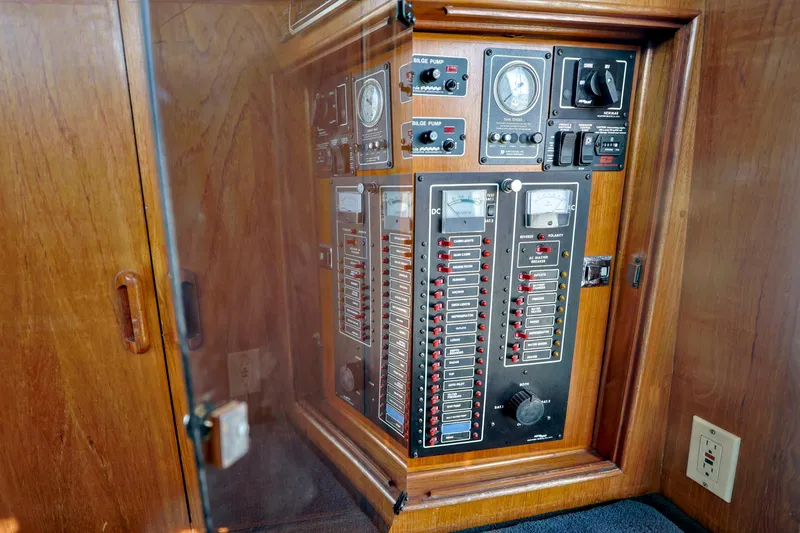 Slide: The Image of Electrical panel inside 1988 Mediterranean 38 Convertible boat, featuring switches and gauges. - 13
