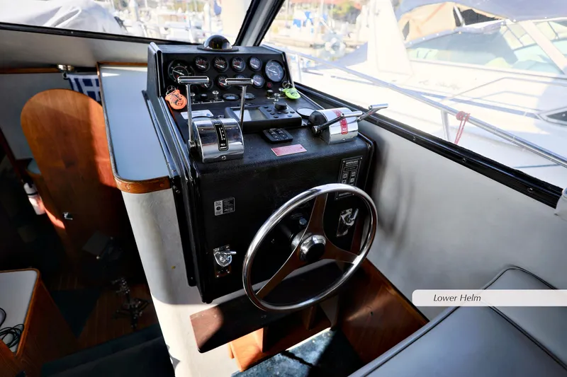 Slide: The Image of 1988 Mediterranean 38 Convertible boat helm with steering wheel and control panel. - 14