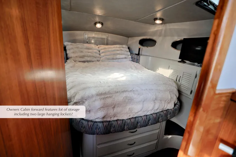 Slide: The Image of Owner's cabin in 1988 Mediterranean 38 Convertible with cozy bed and ample storage. - 19