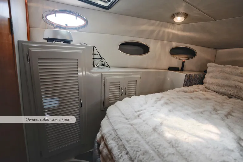 Slide: The Image of 1988 Mediterranean 38 Convertible owner's cabin with cozy bed and storage cabinets. - 21