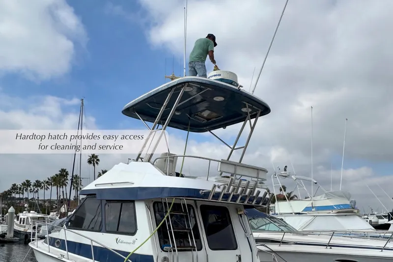 Slide: The Image of 1988 Mediterranean 38 Convertible yacht with hardtop hatch, docked at marina. - 8