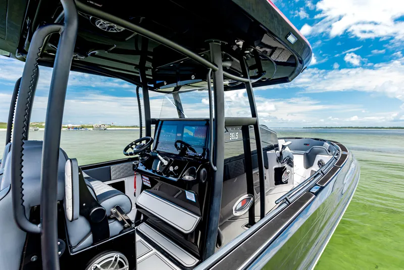 Slide: The Image of 2025 Glasstream GSX boat interior with modern controls and seating on a sunny day. - 14