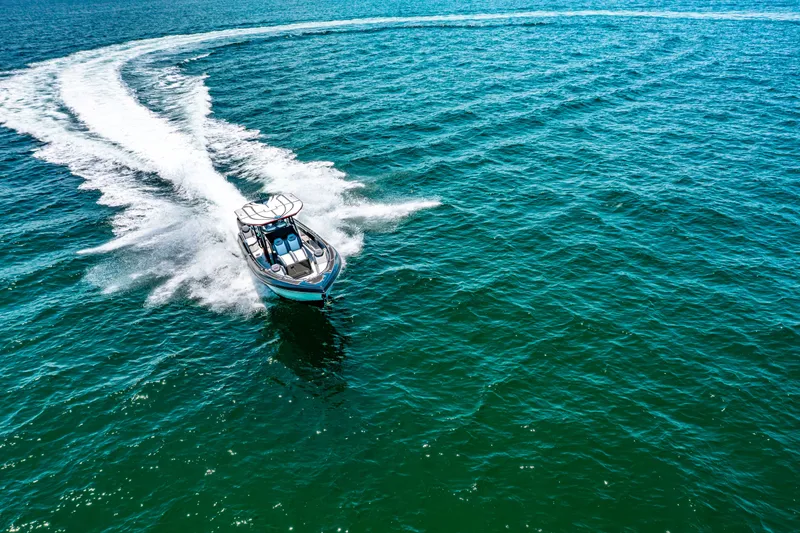 Slide: The Image of 2025 Glasstream GSX boat cruising on open water, leaving a wake trail. - 24