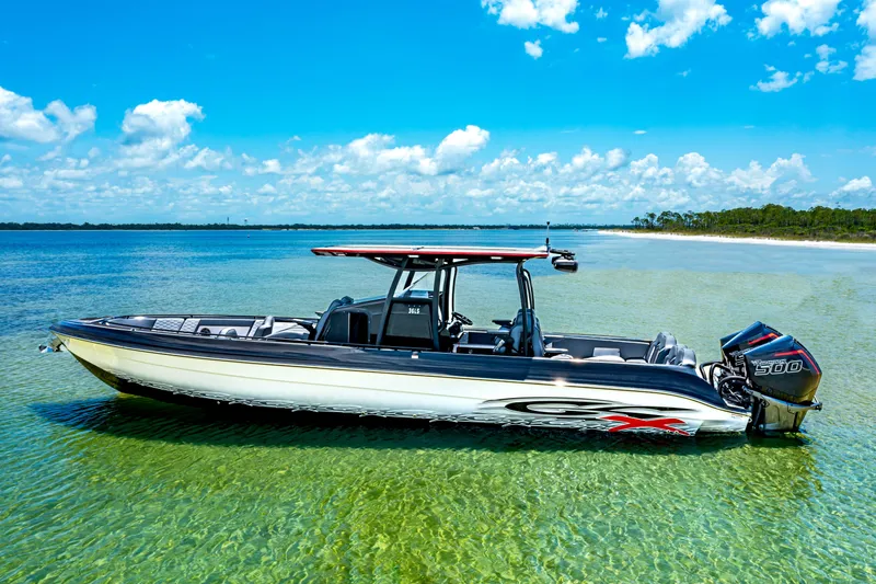 Slide: The Image of 2025 Glasstream GSX boat in clear water, under a bright blue sky. - 7