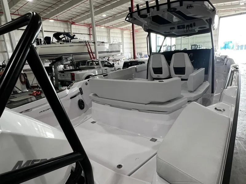 Slide: The Image of 2025 Axopar 29 CCX boat dashboard with steering wheel and controls. - 10