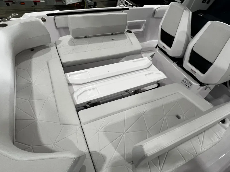 Slide: The Image of 2025 Axopar 29 CCX boat dashboard with steering wheel and control panel. - 12