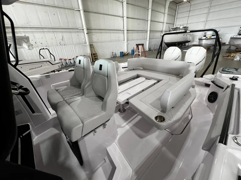 Slide: The Image of 2025 Axopar 29 CCX boat roof hatch with open sky view. - 14