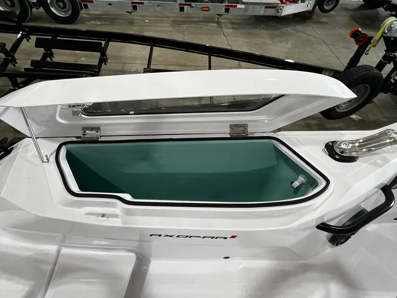Slide: The Image of 2025 Axopar 29 CCX boat interior with open storage compartments and sink. - 16