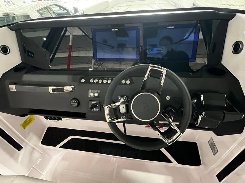 Slide: The Image of 2025 Axopar 29 CCX boat interior with visible seating and storage compartments. - 19