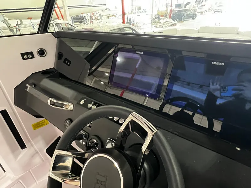 Slide: The Image of 2025 Axopar 29 CCX boat interior with white seating and sleek design. - 21