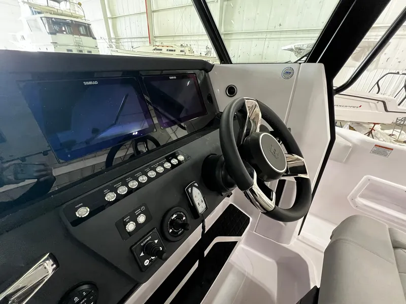 Slide: The Image of 2025 Axopar 29 CCX boat interior with seating and table setup. - 22