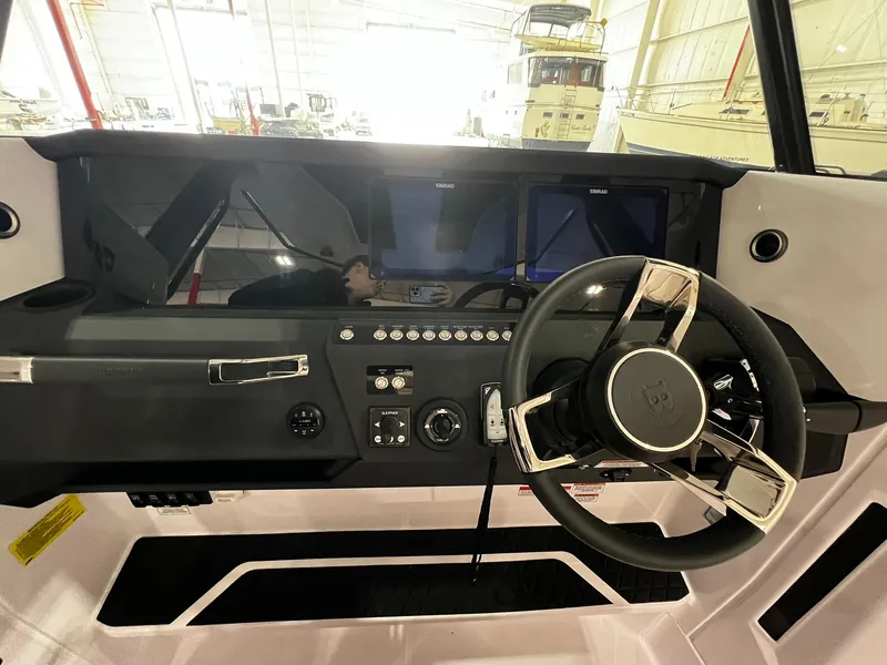 Slide: The Image of 2025 Axopar 29 CCX boat interior with white seating and sleek design. - 23