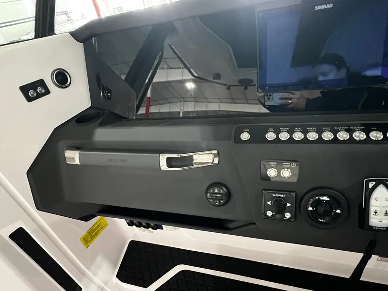 Slide: The Image of 2025 Axopar 29 CCX boat at a car show, surrounded by various vehicles. - 24