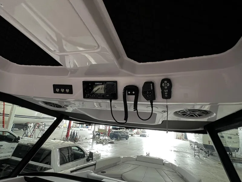 Slide: The Image of 2025 Axopar 29 CCX boat interior with speaker, handle, and control panel. - 25