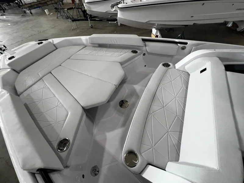 Slide: The Image of 2025 Axopar 29 CCX cabin with compact toilet and cushioned seating. - 32