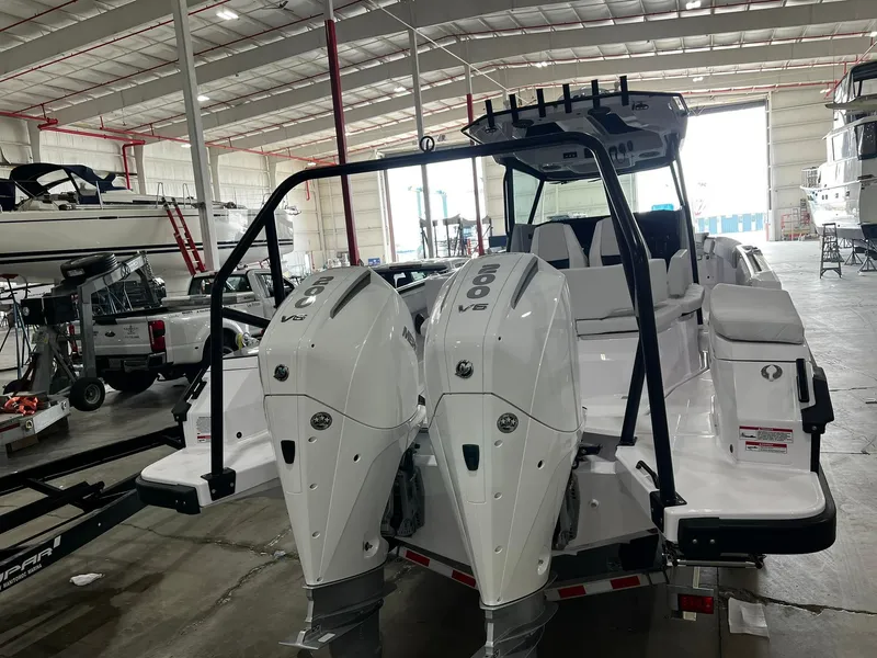 Slide: The Image of 2025 Axopar 29 CCX with twin Mercury outboard engines, rear view. - 4