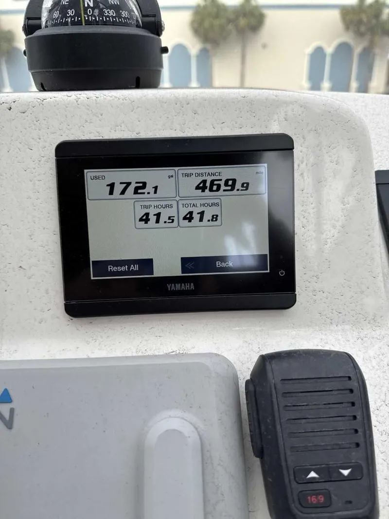 Slide: The Image of Yamaha display on 2023 Cobia 220 DC boat showing trip data and hours. - 5