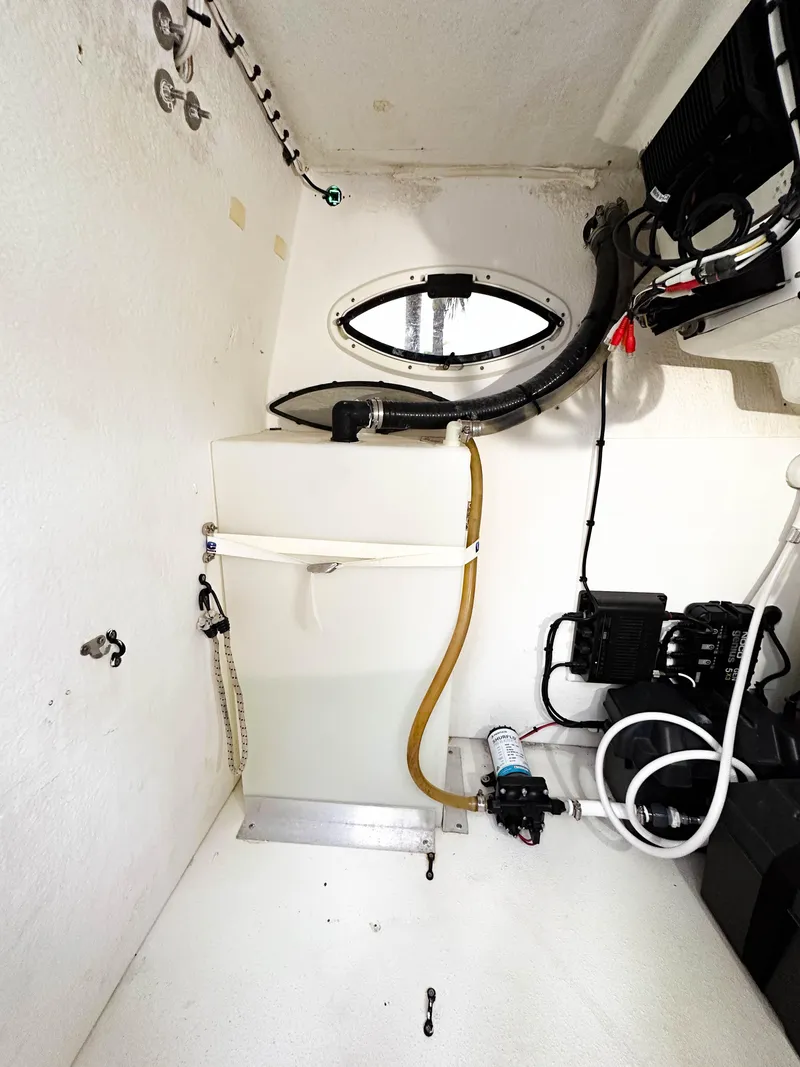 Slide: The Image of Interior of 2013 Twin Vee 26 Center Console boat, featuring storage and equipment. - 11