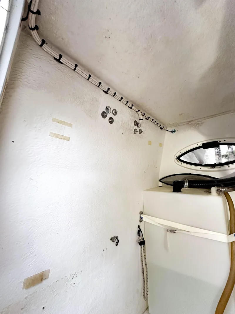 Slide: The Image of Interior view of a 2013 Twin Vee 26 Center Console boat, featuring a compact storage area. - 12