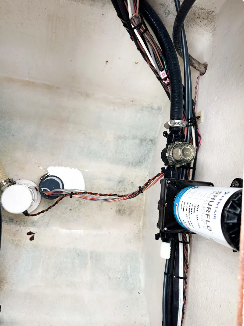 Slide: The Image of 2013 Twin Vee 26 Center Console boat wiring and plumbing components. - 17