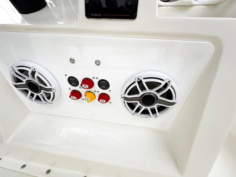 Slide: The Image of Twin Vee 26 Center Console 2013 boat dashboard with speakers and control switches. - 19