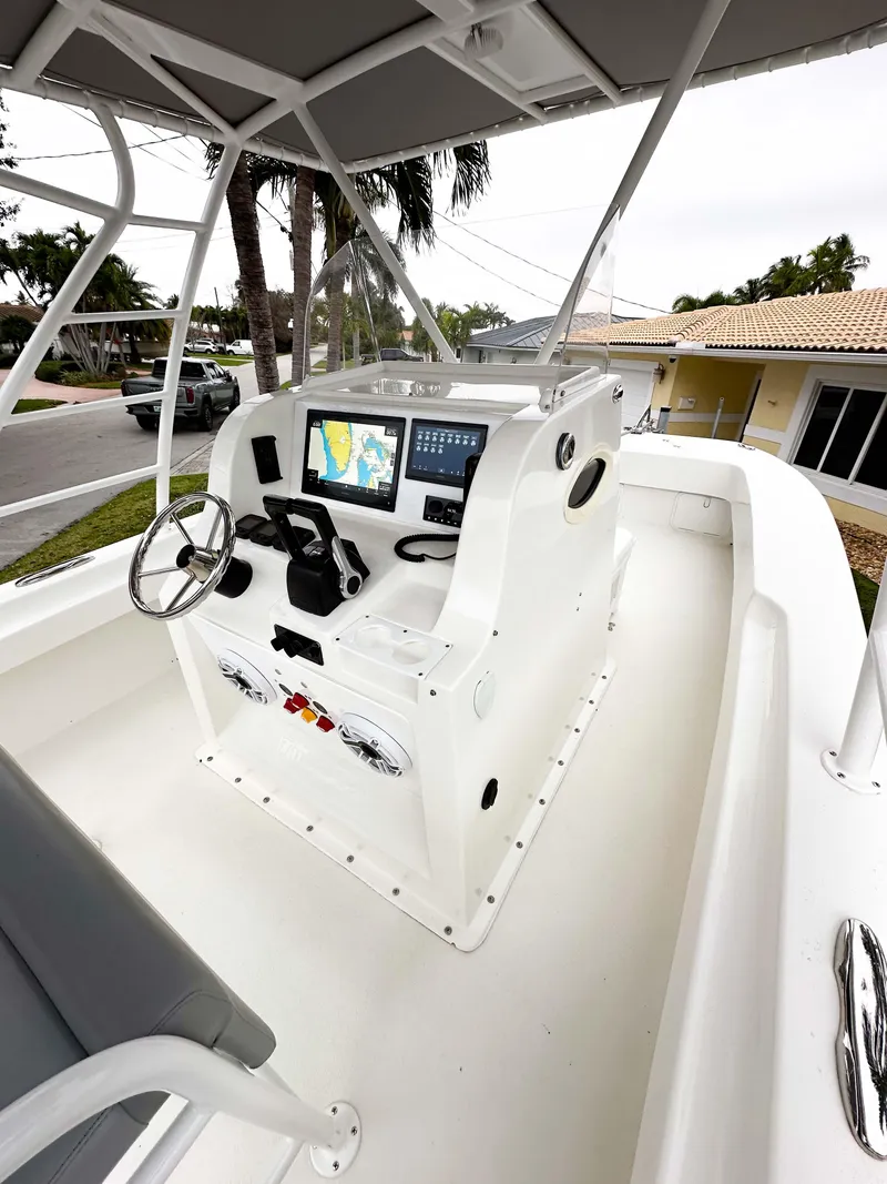 Slide: The Image of 2013 Twin Vee 26 Center Console boat with modern navigation system and spacious deck. - 23