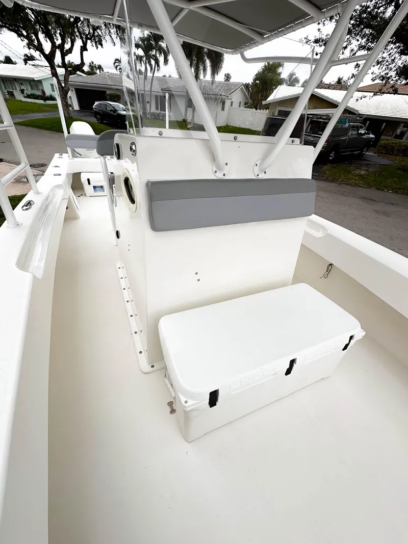 Slide: The Image of 2013 Twin Vee 26 Center Console boat interior with seating and storage. - 27