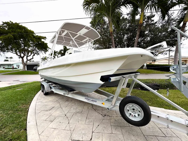 Slide: The Image of 2013 Twin Vee 26 Center Console boat on trailer, parked outdoors. - 4