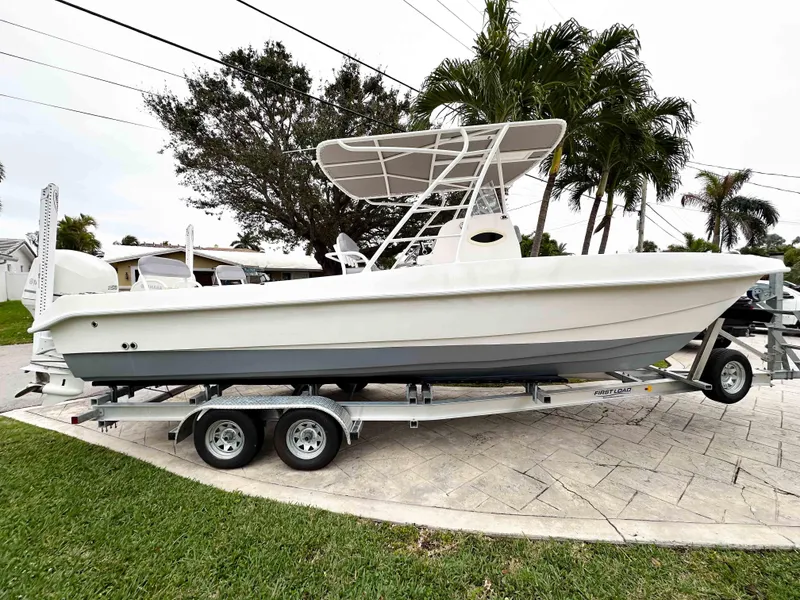 Slide: The Image of 2013 Twin Vee 26 Center Console boat on trailer, parked near palm trees. - 5