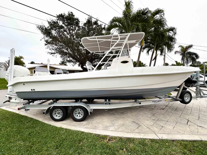 Slide: The Image of 2013 Twin Vee 26 Center Console boat on trailer, parked outdoors. - 6