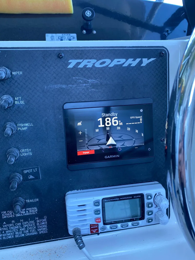 Slide: The Image of 1996 Trophy 2352 Walkaround dashboard with Garmin GPS and marine radio. - 11