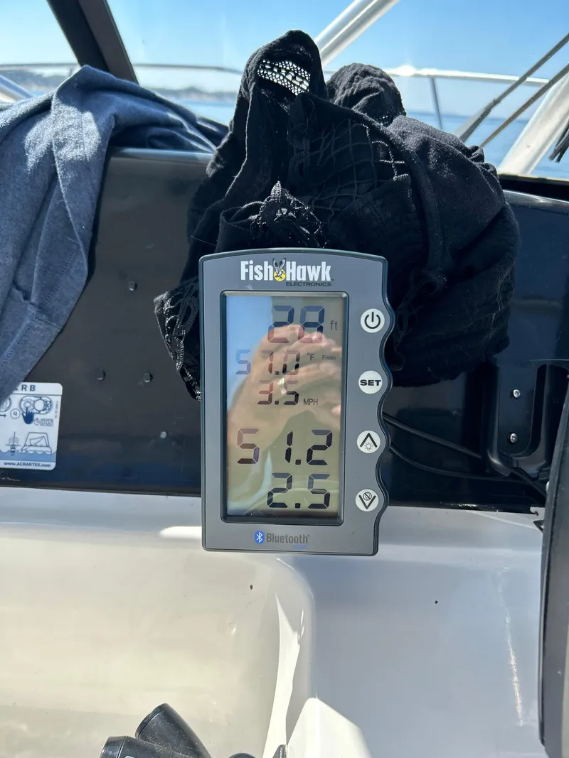 Slide: The Image of FishHawk device on 1996 Trophy 2352 Walkaround boat displaying water temperature and speed. - 13