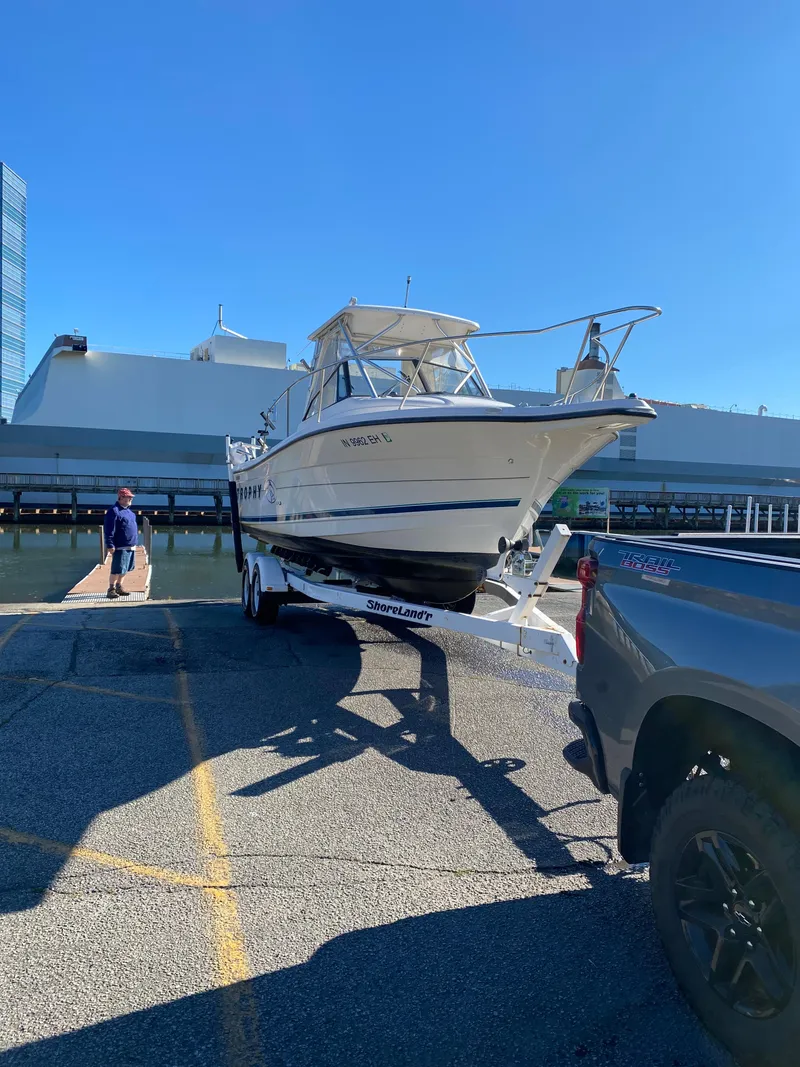 Slide: The Image of 1996 Trophy 2352 Walkaround boat on trailer at dockside, sunny day. - 14