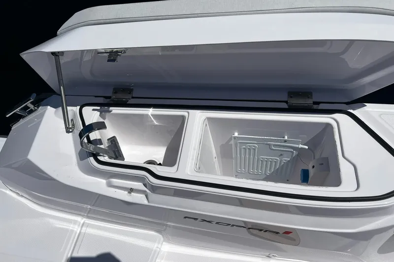 Slide: The Image of Open storage compartment on 2025 Axopar 29 CCX boat, showcasing interior design. - 11
